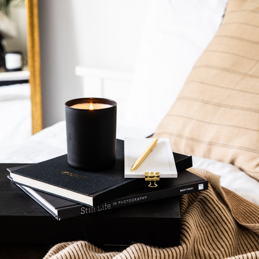 stunning black candle with black books photography